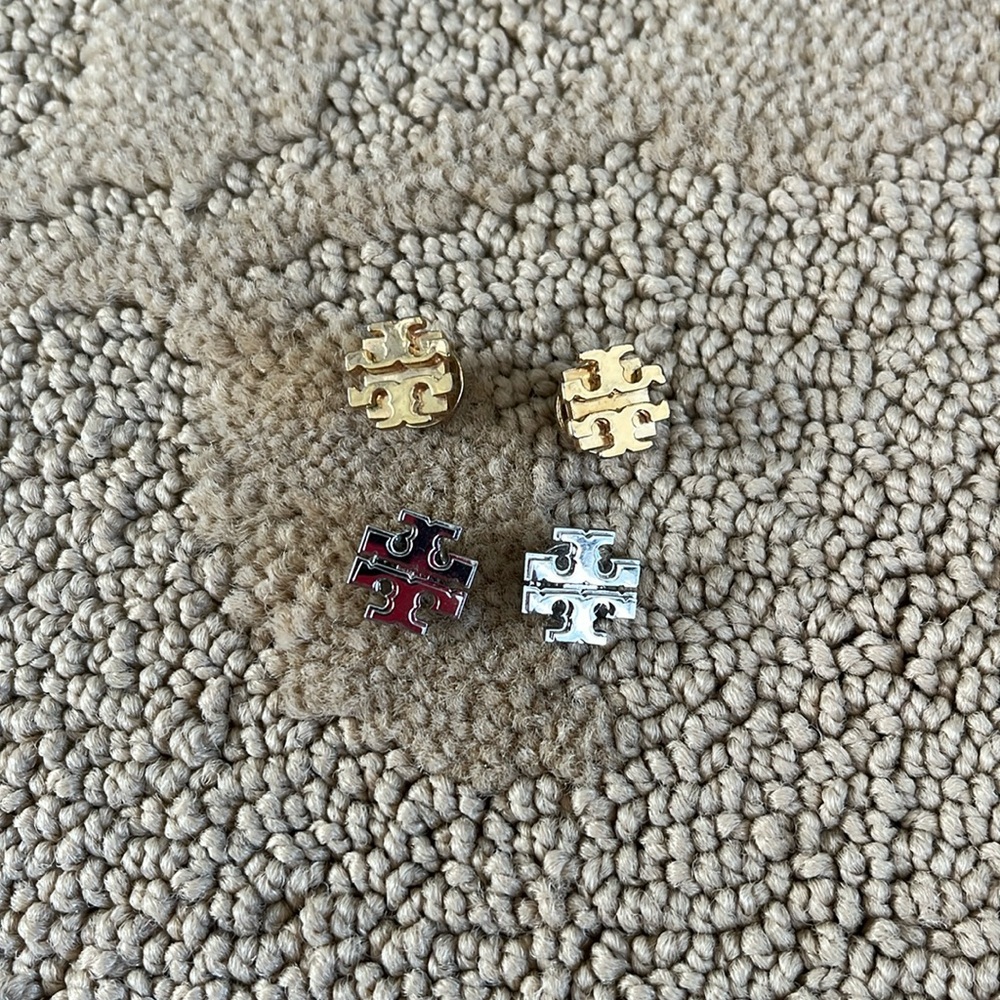 One set of gold and one set of silver Tory Burch studs